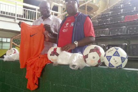 Former head coach of the Golden Jaguars, Jamal Shabazz (right) presenting a quantity of bibs and game balls to co-founder of the Kashif and Shanghai (K&S) Organization, Aubrey ‘Shanghai’ Major yesterday in Trinidad.