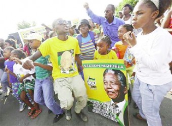 Mourners dance in the street in Soweto where Mandela once lived (Reuters/Yves Herman) 