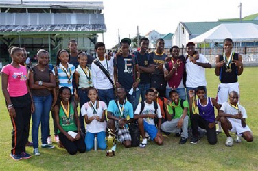 Students of Saint Stanislaus College pose with their individual spoils along with the championship trophy.  