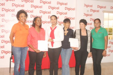 From left to right: Digicel’s Head of Marketing Jacqueline James; two representatives from Lifeline Counselling; Margaret Kertzious and Denise Dias (Help and Shelter) and Communications Manager Digicel, Vidya Sanichara.
