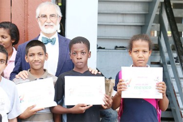 Mexican Ambassador Francisco Olguin poses with three of Joshua House’s six participants in the “This is my Mexico” Children’s Drawing Competition. 