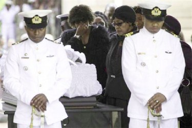 Winnie Mandela, ex-wife of former South African President Nelson Mandela, pays her respects at his coffin as he lies in state at the Union Buildings in Pretoria December 11, 2013. Credit: REUTERS/Marco Longari/Pool 