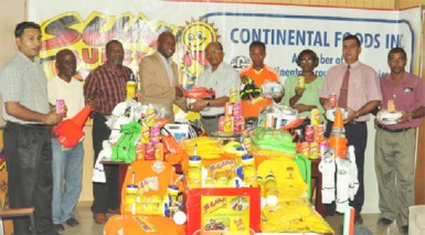 Camptown FC President and attorney-at-law James Bond (fourth from left) receiving the sponsored equipment from Continental Group of Companies corporate secretary Percy Boyce Jr. while other members of the club and company look on. 