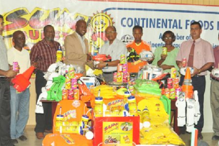 Camptown FC President and attorney-at-law James Bond (fourth from left) receiving the sponsored equipment from Continental Group of Companies corporate secretary Percy Boyce Jr. while other members of the club and company look on.
