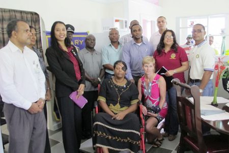 Former prison officer Roxanne Winfield with Stabroek Rotarians and representatives from some of the sponsor agencies at the handing over of her new newly-built disability-friendly home. The home was completely built by prisoners of the Lusignan Prison, according to the Rotary Club. (Rotary Club of Stabroek photo)
