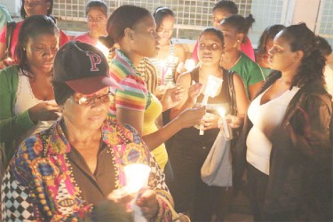 A section of the vigil last evening for four-year-old Jaden Mars who died at the Georgetown Public Hospital, where he was taken for treatment after biting his tongue. His family has vowed not to rest until justice is served. See story on page 10 (Photo by Arian Browne) 