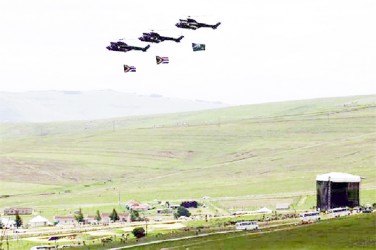 Army helicopters carry South African flags over the burial ground of late former South African President Nelson Mandela during his funeral in Qunu, December 15, 2013. REUTERS/Yannis Behrakis