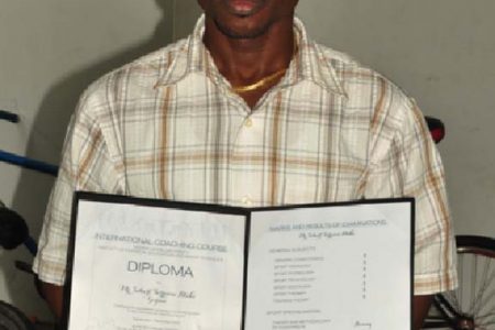 Sebert Blake with his International Coaching Course Diploma in hand. (Orlando Charles photo)