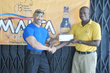 Clayton McKenzie, Banks DIH Brand Manager of Non Alcoholic Malts (right) hands over the sponsorship cheque to Hugh Ross, Chairman of the HRC committee.    