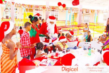 Children at the Ptolemy Reid centre patiently wait their turn as Santa shares out gifts at the Christmas party.  