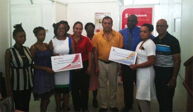 Scotia Bank Marketing Manager Jennifer Cipriani (third from left), a representative of Dr Tulsi Dyal Singh (fourth from left), financial controller of NAMILCO Fitzroy McLeod (third from right) and GPHC CEO, Michael Khan (fourth from right) pose with mothers whose babies are in the Neo-Natal Unit.