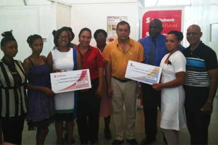 Scotia Bank Marketing Manager Jennifer Cipriani (third from left), a representative of Dr Tulsi Dyal Singh (fourth from left), financial controller of NAMILCO Fitzroy McLeod (third from right) and GPHC CEO, Michael Khan (fourth from right) pose with mothers whose babies are in the Neo-Natal Unit.