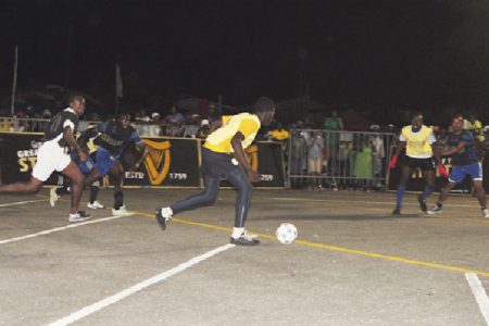 Albouystown B’s Marlon Nedd in the process of taking aim at the Stevedore Housing Scheme goal during their match. (Orlando Charles photo)