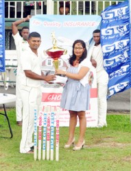 Berbice Captain Sewnarine Chattergoon receives the winning trophy from Hand-in-Hand’s Marketing Coordinator Andrea Jodhan-Khan 