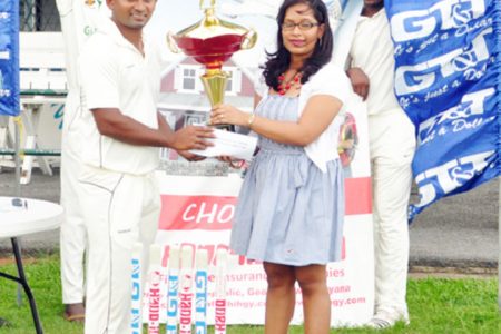 Berbice Captain Sewnarine Chattergoon receives the winning trophy from Hand-in-Hand’s Marketing Coordinator Andrea Jodhan-Khan
