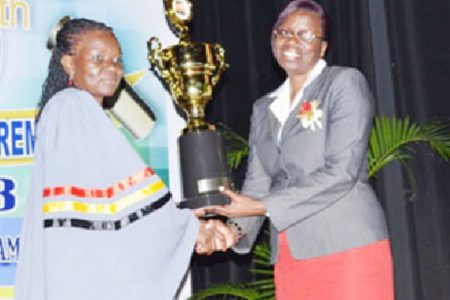  Best graduating teacher Veronica Jeffrey (left) receives the Prime Minister’s prize from Permanent Secretary of the Ministry of Education Delma Nedd  (GINA photo)