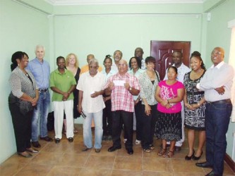 Guyana Goldfields staff pose with the recipients of the donations 
