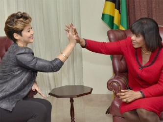 Prime Minister Portia Simpson Miller high-five’s Tessanne Chin 
