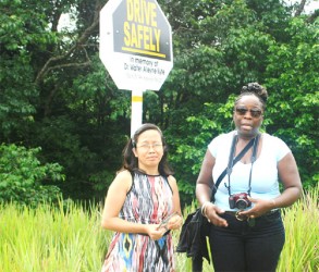 Donette Dennis-Austin with Ms. Jeanette Campbell (plaque in hand) in front of the memorial safety sign 