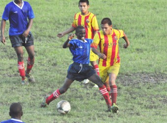 Action in the midfield involving Waramadong and Charlestown Secondary School yesterday at the GFC ground. (Orlando Charles photo)  