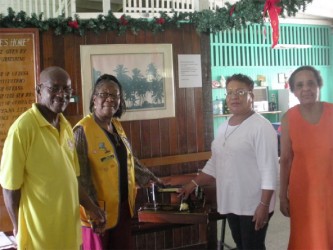 VP of Management Committee Gladwyn Anderson (left), Mickey Anderson (second, left) UEH Administrator Norma Hamilton (second, right) and a resident of the UEH (right). 