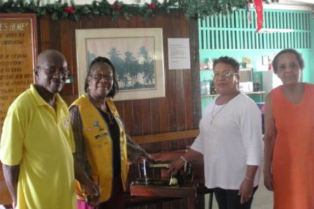 VP of Management Committee Gladwyn Anderson (left), Mickey Anderson (second, left) UEH Administrator Norma Hamilton (second, right) and a resident of the UEH (right).
