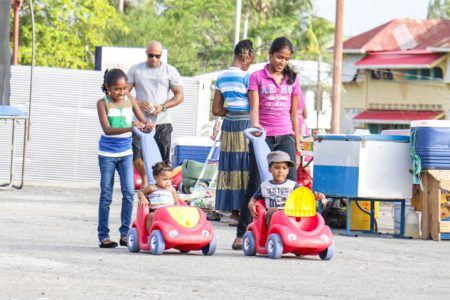Vroom! Vroom! Children enjoying their car rides along the seawall at Kingston, Georgetown yesterday. (Photo by Arian Browne)