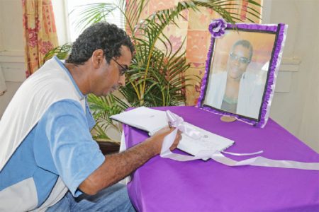 A member of the public signing the Book of Condolence opened at the National Library for the late Chief Librarian Gillian Thompson who was killed in an accident on Christmas Eve Day. (Photo by Arian Browne)