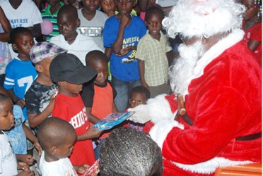 Children receiving gifts from Santa at the Children’s Christmas party at Belladrum (GDF 
