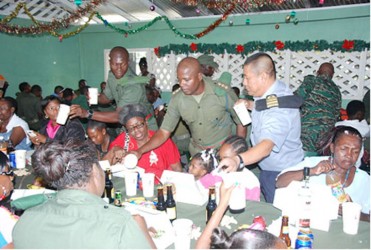 At GDF’s AGRI Corps, Colonel Administration and Quartering, Captain John Flores (right) assists the Corps’ Officer Commanding James Fraser to serve lunch to the troops. (GDF photo)
