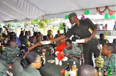 At Base Camp Stephenson, Base Commander Lieutenant Colonel Wilbert Lee serves lunch to the troops. (GDF photo)