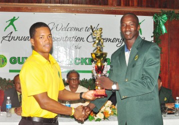 Male Cricketer of the year Leon Johnson Recieves his award his award from chairrman of national selectors Rayon Griffith