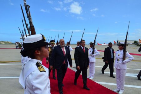 President Donald Ramotar (left) accorded a red carpet welcome in Caracas on his arrival for the PetroCaribe summit on Monday. (Photo via GINA)