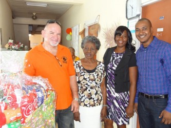 Byer’s Home for Senior Citizens’ representative Pamela Leitch receives hamper from Deputy PS, Human Services Ministry Patrick Findlay (GINA photo)