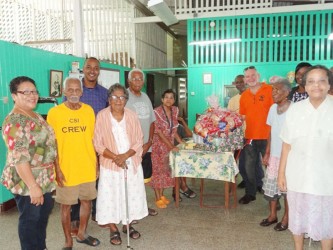 Administrator of the Uncle Eddie’s Home, Norma Hamilton receives the hamper (GINA photo)