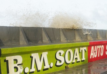 High tides today overtopping the wave wall built by the Ministry of Public Works opposite the Russian Embassy in Kitty.