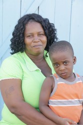 Kathleen Bamfield gives a shy smile as she holds her grandson 