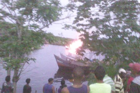 The burning boat can be seen in the foreground