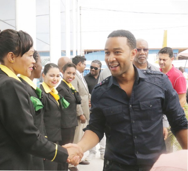 The legend is here: Grammy award winner John Legend arrived here yesterday afternoon for his much-anticipated concert. Here he greets Fly Jamaica crew members at the Ogle International Airport. The Night of Love Concert, an event organised by McNeal Enterprises in collaboration with Hits and Jams Entertainment is set for today at the Guyana National Stadium, Providence. The show will also see performances by Caribbean reggae icon, Beres Hammond and Chutney sensation, KI & JMC 3Veni.  (Arian Browne photo) 