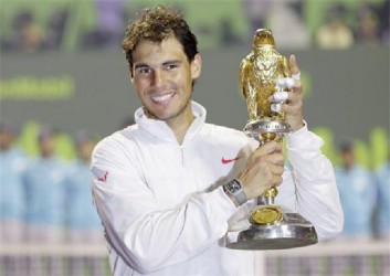 Rafael Nadal of Spain holds his trophy after winning the Qatar Open final tennis match in Doha January 4, 2014. CREDIT: REUTERS/AHMED JADALLAH 