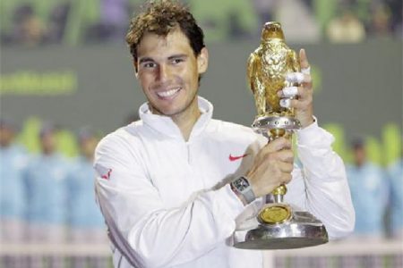 Rafael Nadal of Spain holds his trophy after winning the Qatar Open final tennis match in Doha January 4, 2014. CREDIT: REUTERS/AHMED JADALLAH
