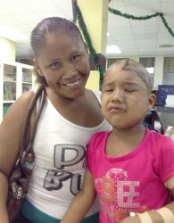Jasmine with her mother in the Paediatric Ward at the Georgetown Public Hospital. Jasmine, 3, who is currently recovering after being mauled by a jaguar last month, appears anguished as she is about to receive another round of medication, which is being delivered intravenously. 