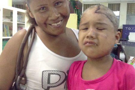 Jasmine with her mother in the Paediatric Ward at the Georgetown Public Hospital. Jasmine, 3, who is currently recovering after being mauled by a jaguar last month, appears anguished as she is about to receive another round of medication, which is being delivered intravenously. 