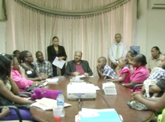 Minister of Health Dr Bheri Ramsaran (centre) meets with children who will be undergoing surgery, along with their parents. (GINA photo)
