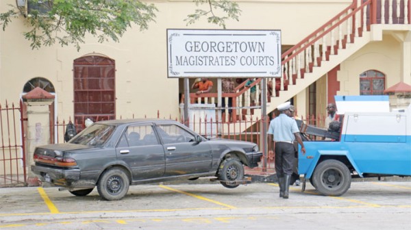 Arrested:  Police yesterday towing away a car which was on the reserved parking lot of the Georgetown Magistrate’s Court. The court will resume operations on Monday after several years of repairs. 