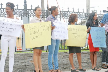 Some of the protesters near Parliament yesterday condemning the police treatment of Colwyn Harding.  Harding has alleged that he was raped by a policeman with a baton and beaten among other indignities. He is now hospitalized at the Georgetown Hospital.
