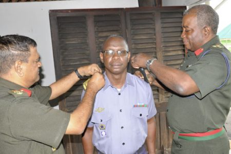The Chief of Staff affixes acting Commander (CG) Orin Porter’s new badge of rank. He is assisted by the Deputy Chief of Staff Colonel Kemraj Persaud. (GDF photo)