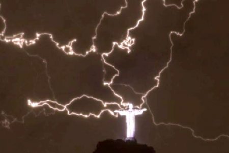 A lightning flashes over the statue of Christ the Redeemer on top of the Corcovado hill in Rio de Janeiro, Brazil, on January 16, 2014. Photo by AFP 