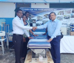 Chief Medical Officer Shamdeo Persaud (left) accepts the donation of medical equipment and OTC medication from CEO of Food for the Poor (Guyana) Inc. Kent Vincent. Behind Persaud are Nadia Coleman, representative from West Demerara Regional Hospital and Allison Christopher, Matron of the Linden Hospital Complex while behind Vincent stands another representative from the Linden Hospital Complex, Donella Drakes. 