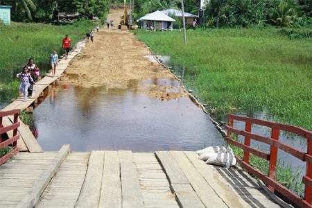 The Moruca Bridge – at left is the walkway built by residents (Photo compliments of the AFC)